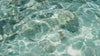 Video of light blue water ripples by Nothing Ahead: https://www.pexels.com/video/stones-on-sea-bottom-12727623/